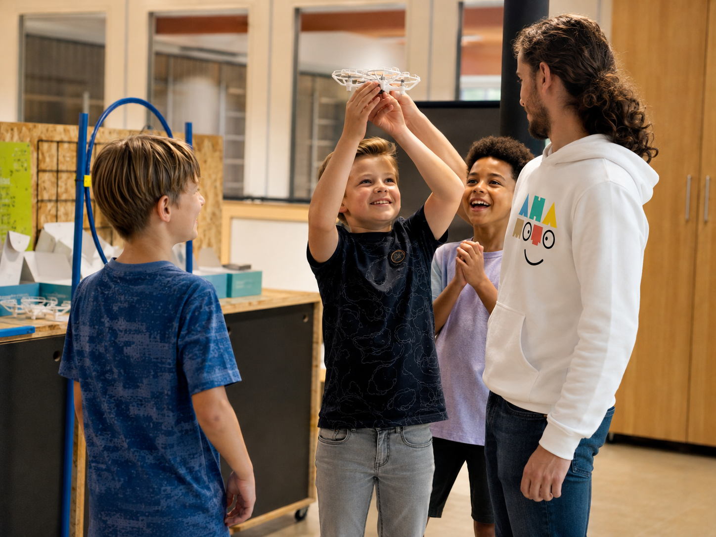 Kinderen laten samen met een Ahamoto-docent een drone opstijgen tijdens de club