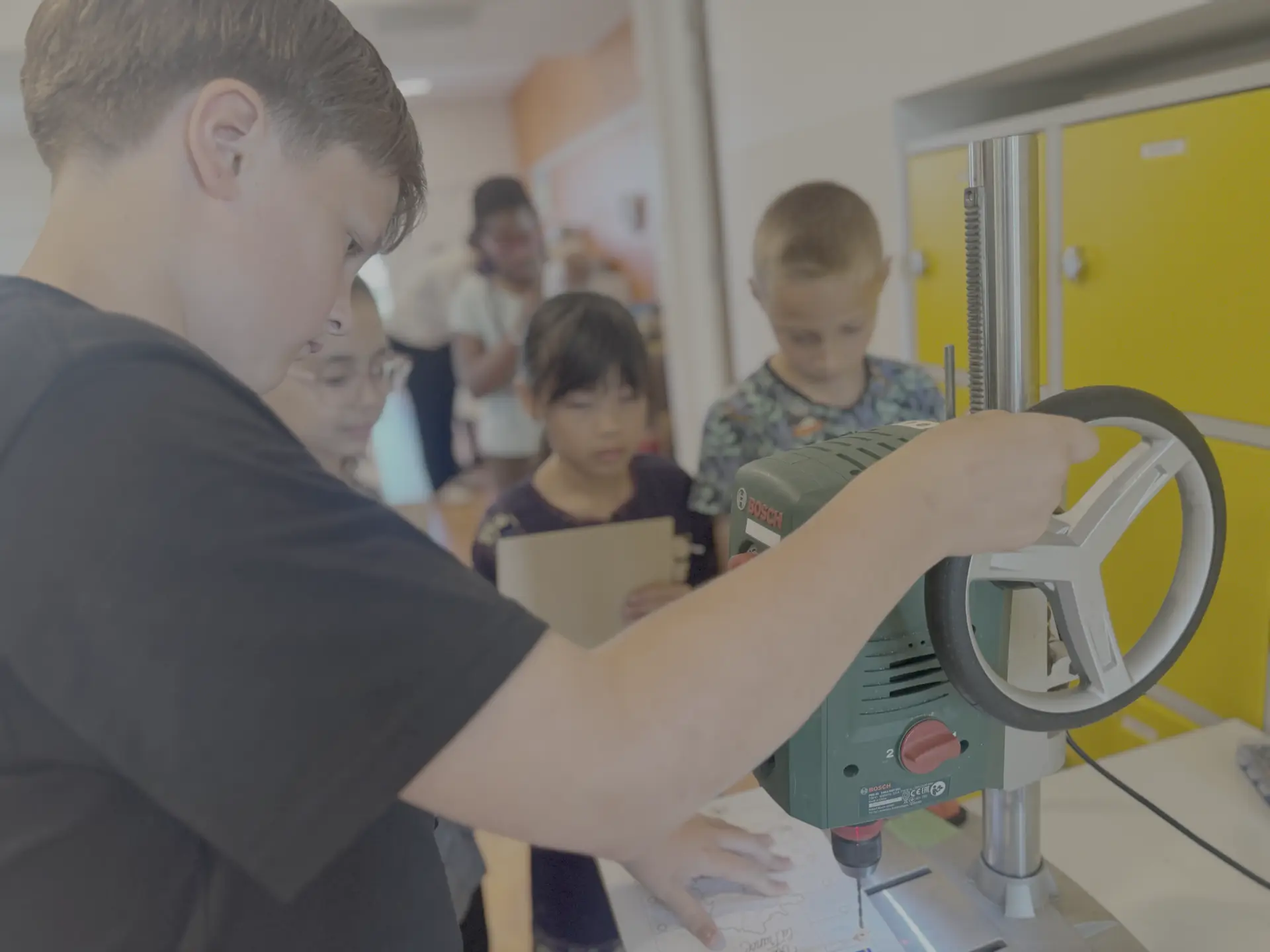 Leerling werkt met de kolomboormachine tijdens de vakmanschapsles